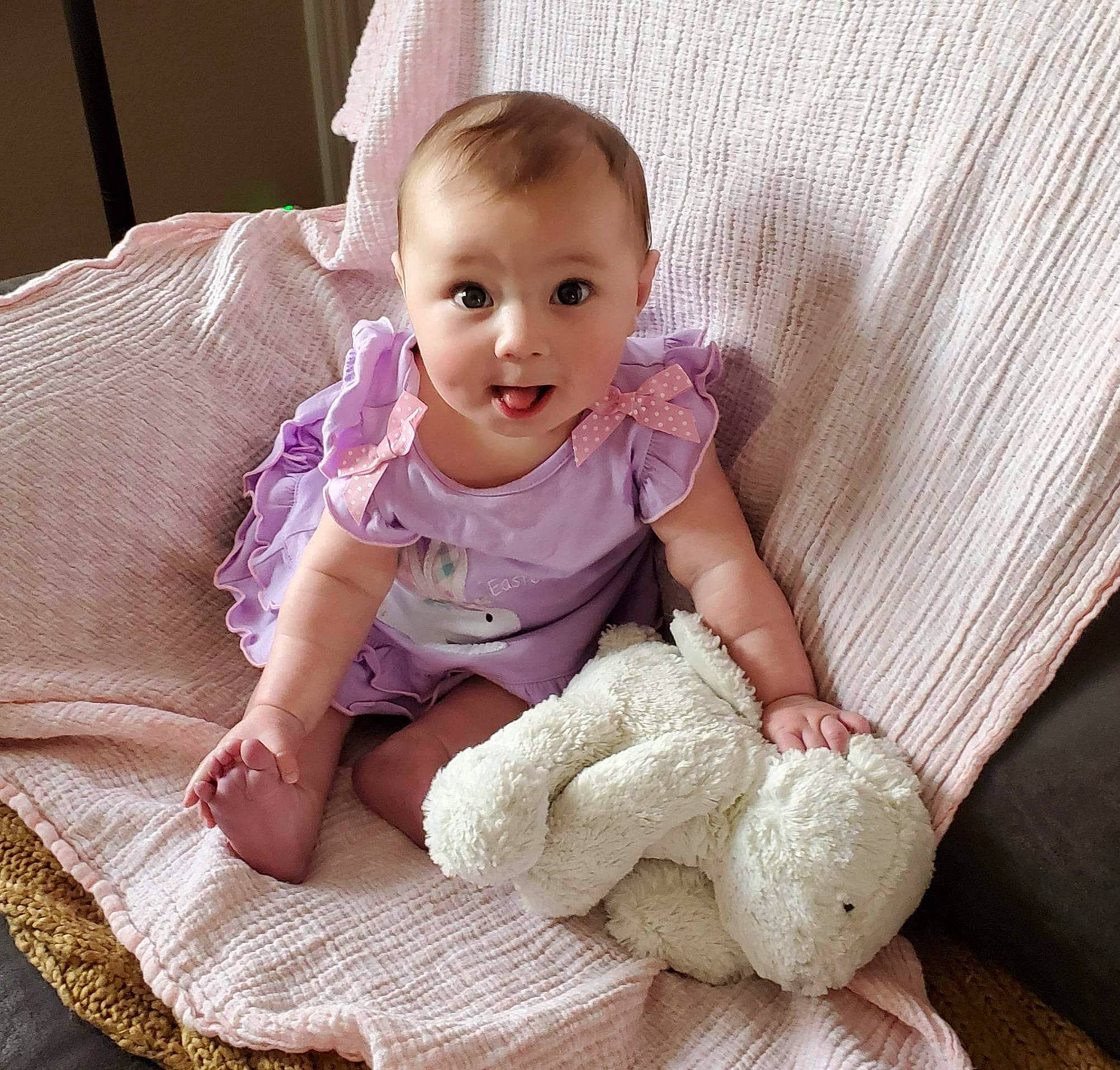 Indie is registered to the contest to win money with this photo: baby, baby_sleeping, baby_toddler_clothing, cheek, child, comfort, face, finger, head, headgear, iris, linens, person, pink, purple, skin, sleeve, smile, sock, surprise