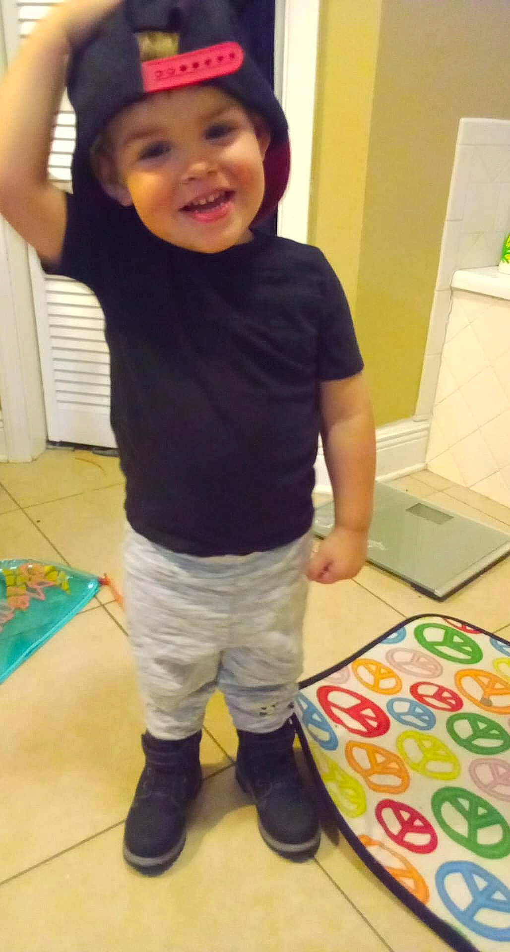 Bradley joined the competition — help win amazing prizes! baby_toddler_clothing, child, floor, flooring, fun, happy, headwear, human_body, human_leg, joy, knee, leg, paint, person, play, room, shorts, sleeve, smile, sportswear