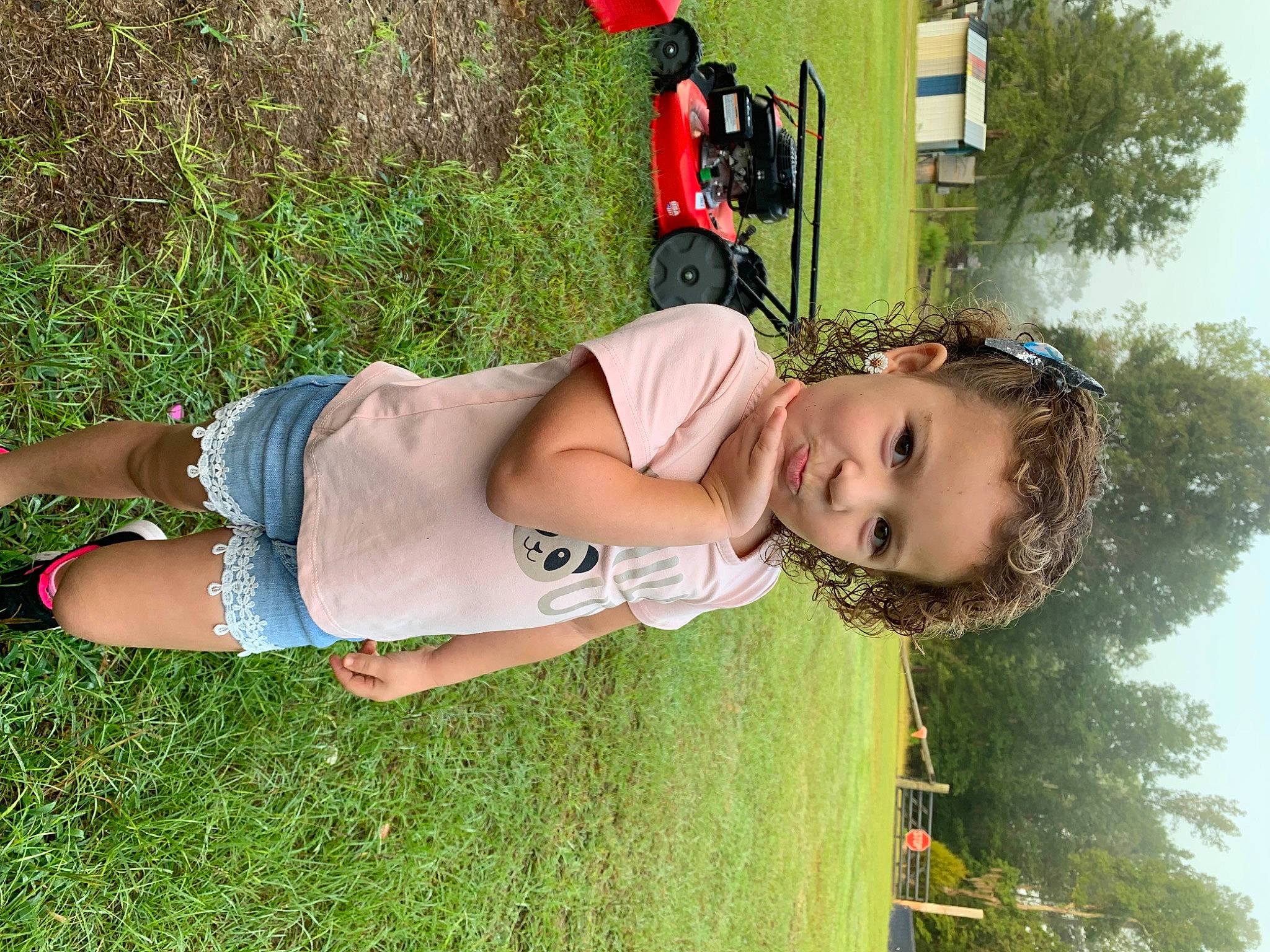 Brooklynn is registered to the contest to win money with this photo: arm, car, child, clothing, fun, grass, grassland, green, happy, human_leg, leisure, people_in_nature, person, plant, recreation, thigh, tire, tree, trunk, wheel