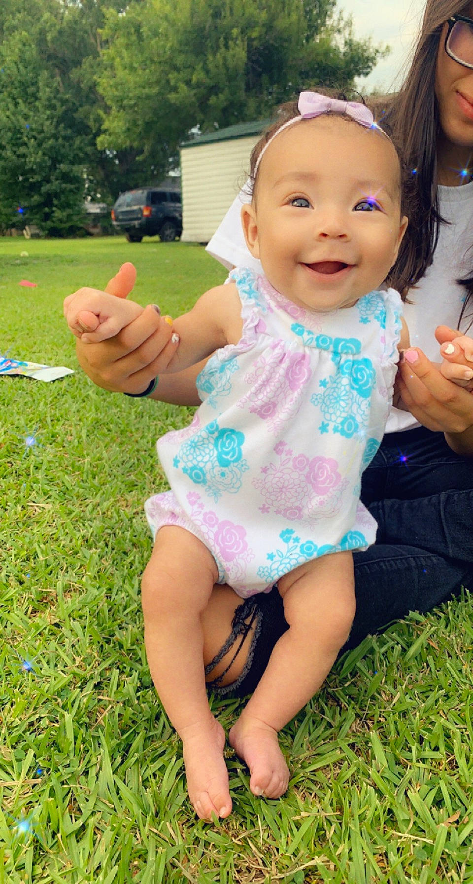 Bayleigh is registered to the contest to win money with this photo: baby_toddler_clothing, face, finger, fun, gesture, grass, grass_family, green, hand, happy, joy, leg, leisure, people_in_nature, person, pink, plant, skin, smile, summer