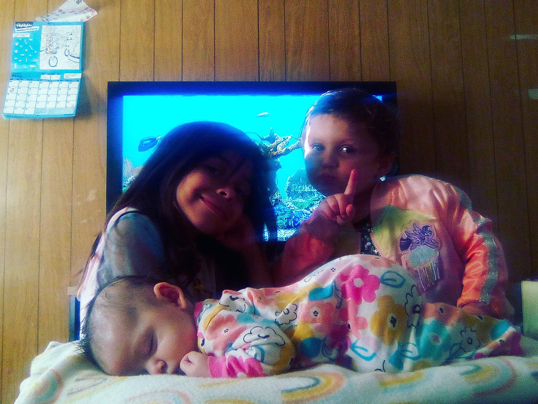 Ascilla is registered to the contest to win money with this photo: baby, bedding, bedtime, child, comfort, display_device, electronic_device, event, flesh, fun, gadget, happy, lap, linens, person, room, sitting, t_shirt, television, television_set