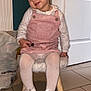 bow, child, cute, door, earrings, floor, indoor, person, pink_pinafore, plastic_bag, radiator, sitting, small_stool, smiling, tile_floor, toddler, toy, white_shoes, white_tights, young_child