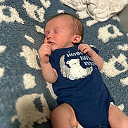 Princeton is registered to the contest to win money with this photo: baby, newborn, sleeping, onesie, blue, blanket, pattern, infant, cute, clothing, lying_down, peaceful, soft_focus, toddler, child, portrait, cozy, cute_baby, resting, indoor