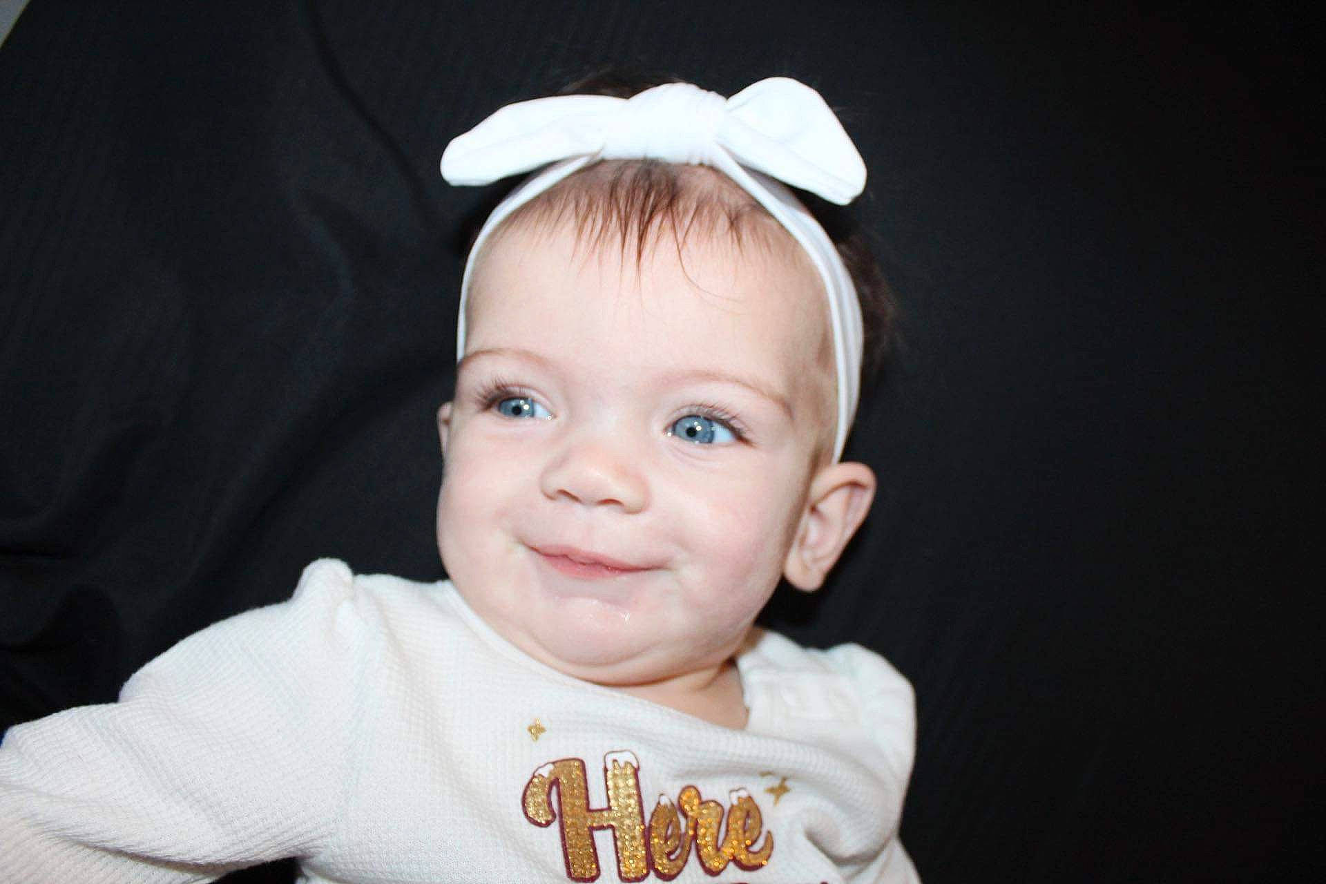 Hayven is registered to the contest to win money with this photo: baby, baby_toddler_clothing, cheek, chin, costume_hat, ear, eye, eyebrow, eyelash, flash_photography, hair_accessory, happy, headband, headpiece, jewellery, joy, person, sleeve, smile, t_shirt