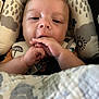 baby, infant, face, hands, cushion, baby_seat, blanket, close_up, child, cute, fingers, pattern, cloud, raindrop, soft, indoor, person, young, wearing, comfort