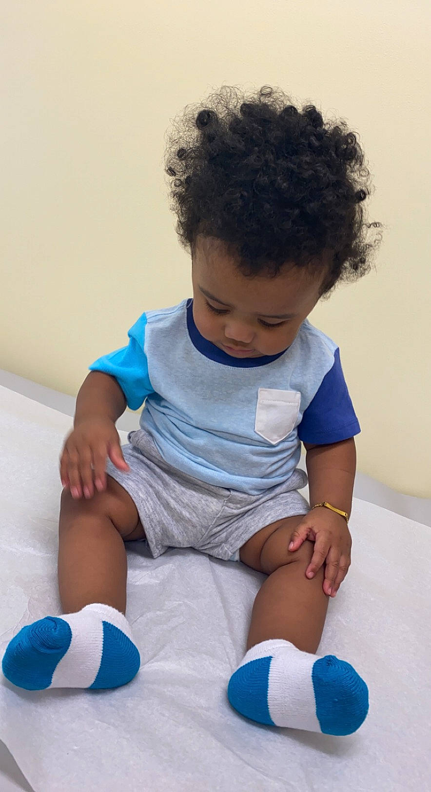 Travon is registered to the contest to win money with this photo: arm, azure, baby, baby_playing_with_toys, baby_toddler_clothing, child, comfort, finger, happy, joint, knee, leg, leisure, person, product, skin, sleeve, sock, t_shirt, thigh