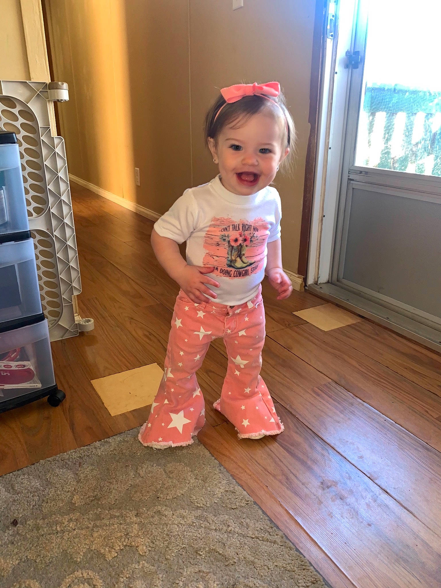 Charli is registered to the contest to win money with this photo: baby, baby_toddler_clothing, child, door, face, floor, flooring, foot, fun, hardwood, joy, laminate_flooring, magenta, person, product, skin, sleeve, standing, toddler, varnish