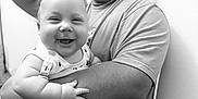 Gabriel participe au concours pour gagner de l'argent avec cette photo : arm, baby, black_and_white, chair, child, clothing, cute, expression, hair, happy, holding, indoor, man, pacifier, person, playful, seat, skin, smile, tongue