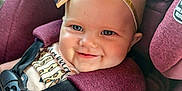 Journey is registered to the contest to win money with this photo: baby, child, car_seat, headband, leopard_print, bow, smile, blue_eyes, infant, seatbelt, child_safety, cute, happy, portrait, closeup, pink_clothing, plush, car_interior, straps, young_child