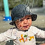 animal_print, bucket_hat, cheetah, child, closeup, cute, expression, face, fun, giraffe, hat, monkey, outdoor, play, shirt, splash, summer, sunlight, toddler, water
