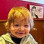 Oakley is registered to the contest to win money with this photo: toddler, child, smile, face, hair, hoodie, clothing, indoor, restaurant, wooden_booth, poster, coffee, blond_hair, happy, portrait, young_child, casual, seated, curly_hair, light