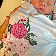 Iris is registered to the contest to win money with this photo: newborn, baby, sleeping, blanket, floral, hat, person, hands, bed, comfort, rest, cozy, indoors, closeup, peaceful, soft, infant, wrapped, portrait, tenderness