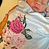 newborn, baby, sleeping, blanket, floral, hat, person, hands, bed, comfort, rest, cozy, indoors, closeup, peaceful, soft, infant, wrapped, portrait, tenderness