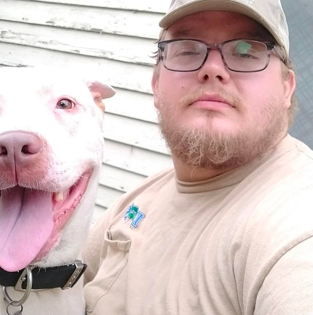 Dime is registered to the contest to win money with this photo: baseball_cap, beard, cap, carnivore, collar, companion_dog, cool, dog, dog_breed, eyewear, fawn, glasses, happy, jaw, mouth, selfie, t_shirt, vision_care, white, working_animal