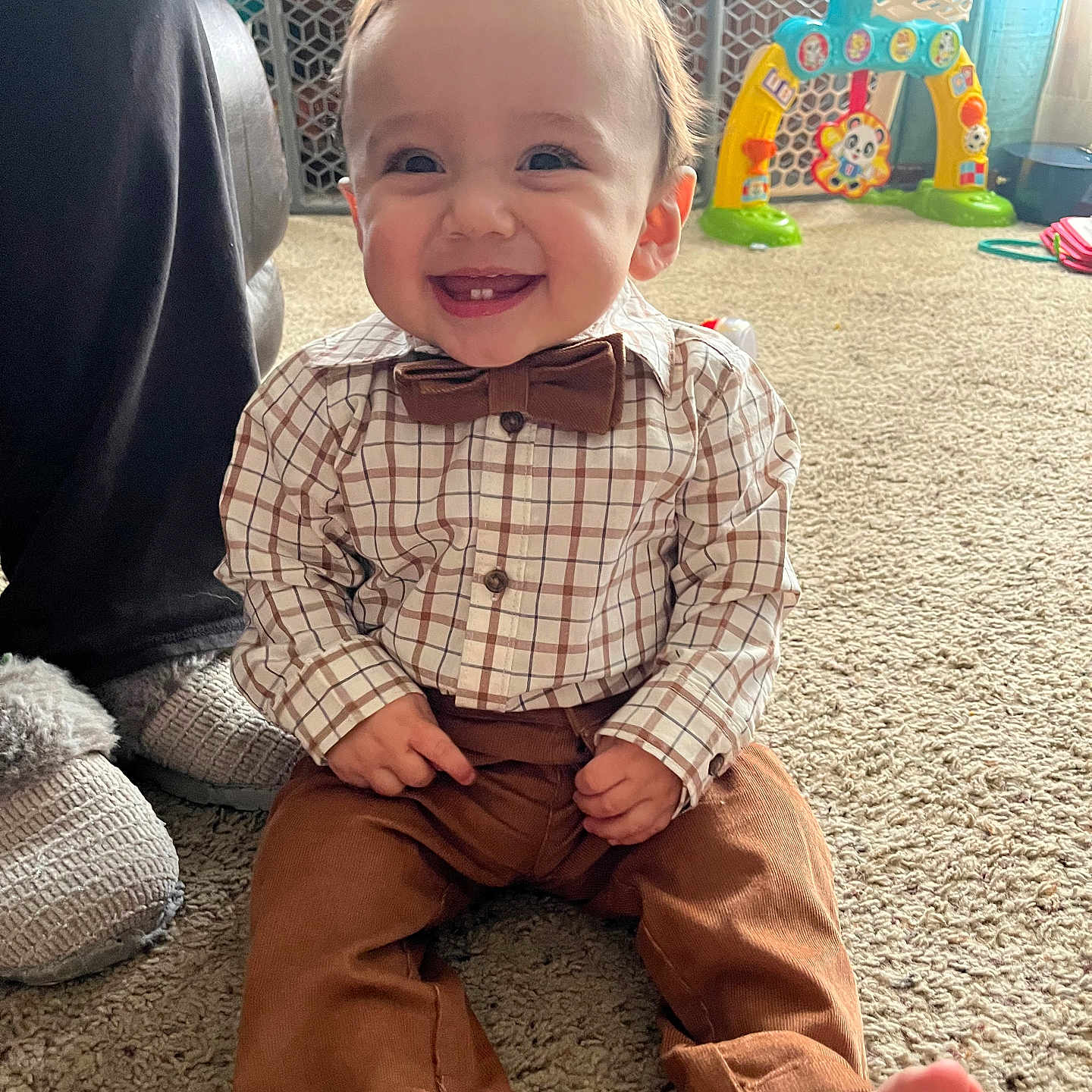 Ezekiel is registered to the contest to win money with this photo: accessories, adult, baby, clothing, face, female, formalwear, happy, head, indoors, jeans, laughing, pants, person, photography, portrait, sitting, smile, tie, woman