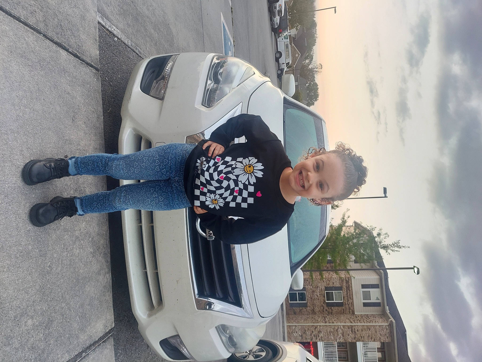 Mahayla joined the competition — help win amazing prizes! automotive_design, automotive_exterior, automotive_lighting, automotive_tire, car, cloud, hood, jeans, joy, motor_vehicle, person, sky, smile, tire, toddler, tree, trunk, vehicle, vehicle_door, wheel