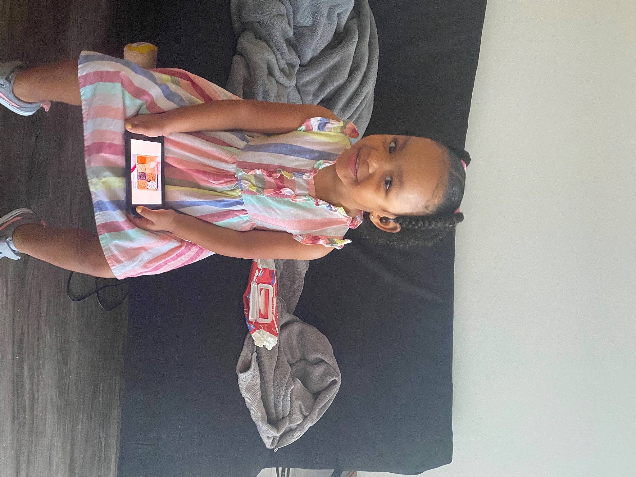 Layla is registered to the contest to win money with this photo: baby, baby_carriage, baby_products, baby_toddler_clothing, bicycle_wheel, dress, fun, human_leg, joy, knee, leg, person, sandal, sitting, t_shirt, thigh, tire, toddler, tree, wheel