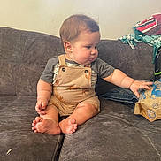 Roman joined the competition — help win amazing prizes! baby, casual, child, childhood, clothing, couch, curious, face, foot, furniture, hand, home, indoor, infant, overalls, paper_bag, plush, sitting, sofa, wall