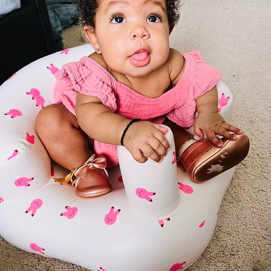 Walthour joined the competition — help win amazing prizes! baby, child, curly_hair, pink_outfit, inflatable_seat, pink_bunnies, carpet, indoor, cute, tongue_out, shiny_shoes, white_cup, playful, seated, small_ears, bright_eyes, adorable, infant, hand_grip, portrait