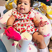 Walthour joined the competition — help win amazing prizes! baby, blanket, bunny_pattern, child, colorful, cup, curly_hair, cute, dress, earrings, indoor, infant, inflatable_seat, person, pillow, pink_socks, portrait, smiling, strawberry_pattern, watermelon_pattern