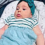 Alisha joined the competition — help win amazing prizes! arm, baby, blanket, blue_skirt, child, clothing, curious, cute, face, headband, indoor, infant, lying_down, moon, newborn, portrait, puckered_lips, soft_fabric, stars, striped_shirt