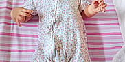 Alisha joined the competition — help win amazing prizes! baby, bear, bed, child, cute, floral_pattern, headband, indoors, infant, lying_down, onesie, pink, plush_toy, portrait, sleepwear, small_feet, small_hands, soft_toys, striped_blanket, turtle