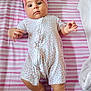 baby, bear, bed, child, cute, floral_pattern, headband, indoors, infant, lying_down, onesie, pink, plush_toy, portrait, sleepwear, small_feet, small_hands, soft_toys, striped_blanket, turtle