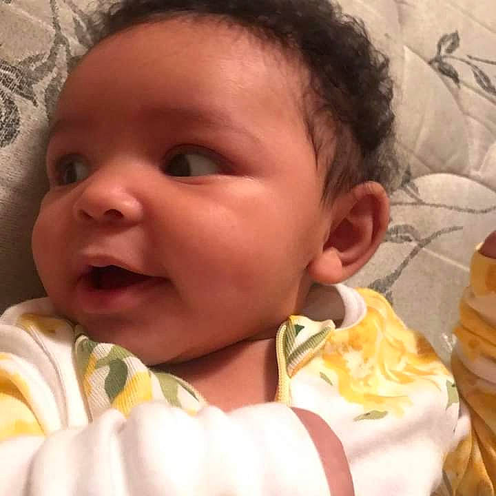 Serenity is registered to the contest to win money with this photo: baby, baby_toddler_clothing, cheek, chin, comfort, eye, eyebrow, eyelash, face, happy, iris, linens, lip, mouth, nose, person, skin, sleeve, smile, thumb