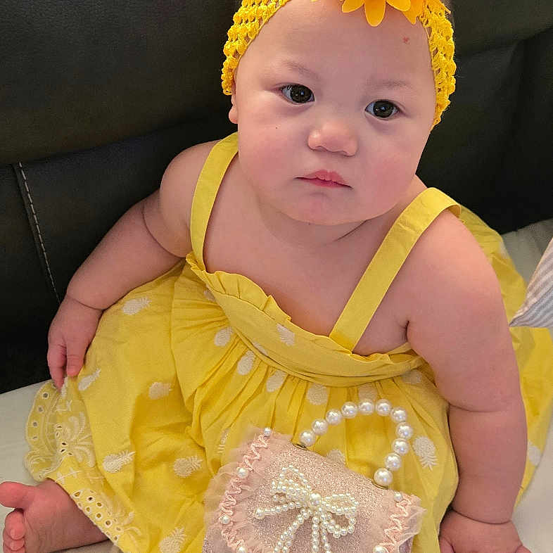 Melody Reign joined the competition — help win amazing prizes! baby, bed, black_leather, child, couch, cushion, cute, decor, flower, headband, indoor, infant, pearl, person, portrait, purse, sitting, skin, soft_toys, yellow_dress