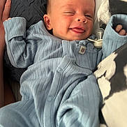 Harvey joined the competition — help win amazing prizes! baby, infant, smiling, winking, tongue_out, blue_onesie, pacifier, blanket, cozy, sleepwear, cute, child, newborn, hand, face, portrait, lying_down, soft_texture, indoors, relaxed