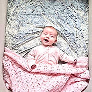 Maisie joined the competition — help win amazing prizes! baby, blanket, child, comfort, cozy, crib, cushion, cute, fabric, happy, indoors, infant, knitted, pink, portrait, resting, sleepwear, smile, soft, texture