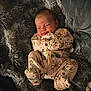 Maisie joined the competition — help win amazing prizes! baby, infant, sleeping, onesie, floral_pattern, blanket, soft_texture, cozy, cute, child, newborn, smiling, resting, indoors, portrait, warm, comfort, toddler, clothing, peaceful