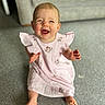 baby, carpet, child, cute, expression, face, floor, furniture, happy, home, indoor, infant, living_room, person, pink_dress, playful, sitting, smiling, tongue_out, young_child