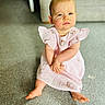 baby, carpet, child, couch, cute, eyes, floor, foot, furniture, hair, hands, head, indoor, person, pink_dress, portrait, serious_expression, sitting, skin, young_child