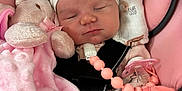 Marley is registered to the contest to win money with this photo: baby, blanket, car_seat, child, clothing, cute, headband, indoors, infant, newborn, pacifier, peaceful, pink, plush_toy, resting, safety_harness, sleeping, soft_toy, toddler, white
