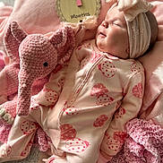 Marley is registered to the contest to win money with this photo: 1_month, baby, blanket, bow, child, cozy, crocheted, cute, elephant, headband, indoors, infant, milestone, newborn, onesie, pink, portrait, sign, sleeping, soft_toy