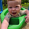 Zoey is registered to the contest to win money with this photo: baby, child, swing, green_swing, outdoor, park, smiling, happy, playground, sunlight, grass, trees, summer, cute, infant, joyful, nature, person, clothing, close_up
