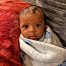 baby, blanket, child, cozy, cushion, cute, expression, eyes, face, home, indoors, infant, person, pillow, portrait, snug, soft_texture, warm, wrapped, young