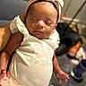 Ocean is registered to the contest to win money with this photo: arm, baby, blurred_background, bow, child, cradling, cute, floral_pattern, headband, indoor, infant, newborn, peaceful, person, pink, portrait, sleeping, soft_lighting, tutu, white_clothing