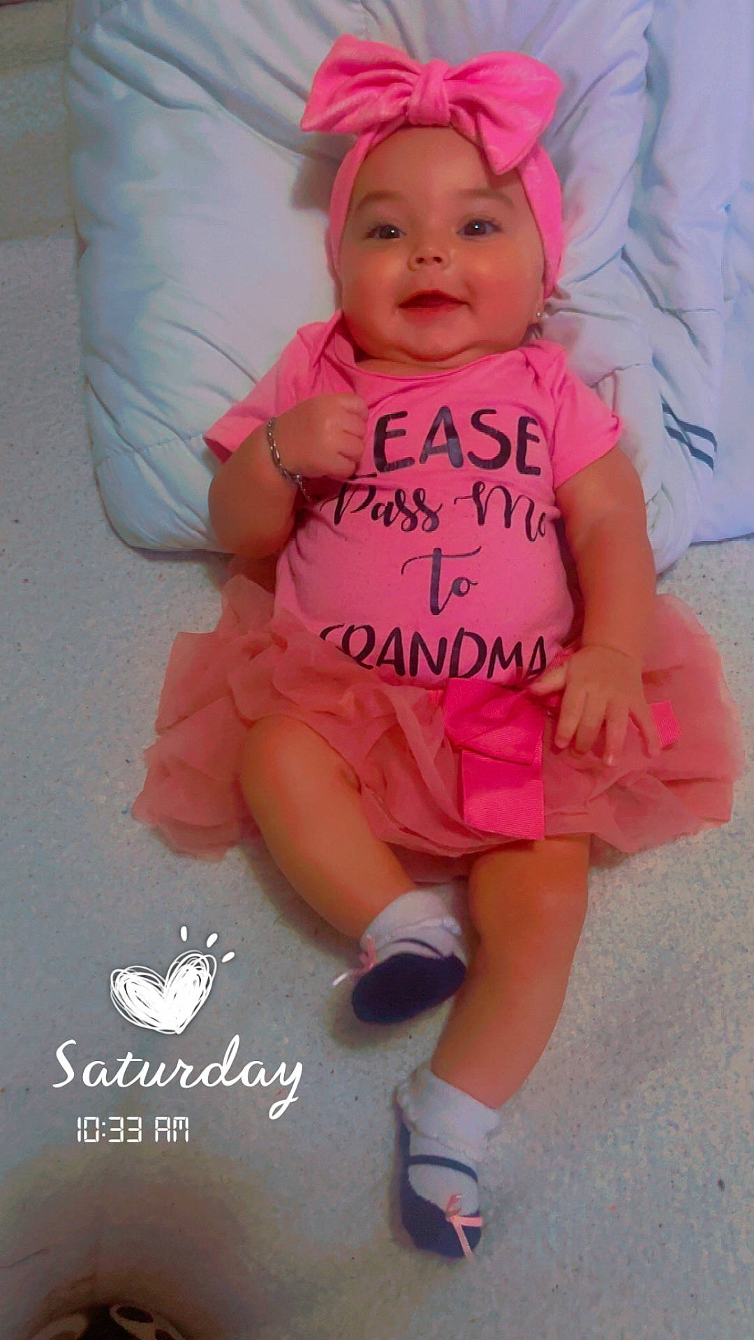 Kehlani joined the competition — help win amazing prizes! baby, bed, bow, child, dress, happy, headband, heart_doodle, indoor, infant, photography, pillow, pink_outfit, portrait, sitting, smiling, socks, text_on_clothing, thumbs_up, timestamp