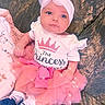 Kehlani is registered to the contest to win money with this photo: baby, infant, child, portrait, pink, dress, tutu, headband, bow, blanket, sitting, lying_down, face, eyes, smiling, indoor, fashion, sparkles, royal, clothing