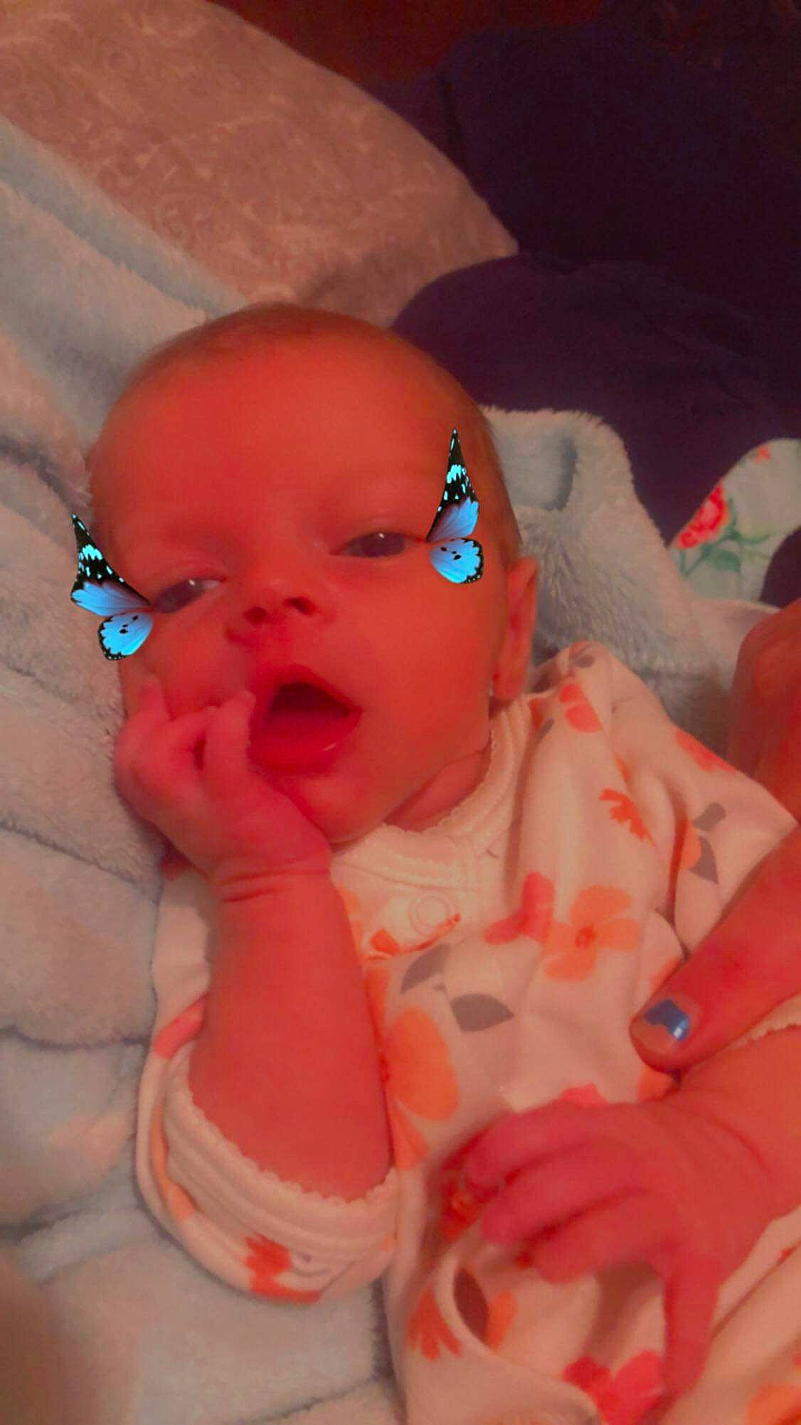 Creedence is registered to the contest to win money with this photo: baby, baby_toddler_clothing, cheek, chin, eye, eyebrow, facial_expression, finger, human_body, iris, lip, mouth, nose, orange, person, pink, product, skin, sleeve, smile