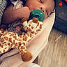 baby, sleeping, pacifier, plush_toy, giraffe, blanket, bottle, infant, cute, indoors, heart_filter, soft, peaceful, child, floor, carpet, hand, face, resting, cozy