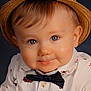baby, child, face, hat, blue_eyes, smile, bow_tie, shirt, candy_cane, santa_claus, portrait, cute, infant, fashion, holiday_theme, closeup, expression, studio, adorable, person