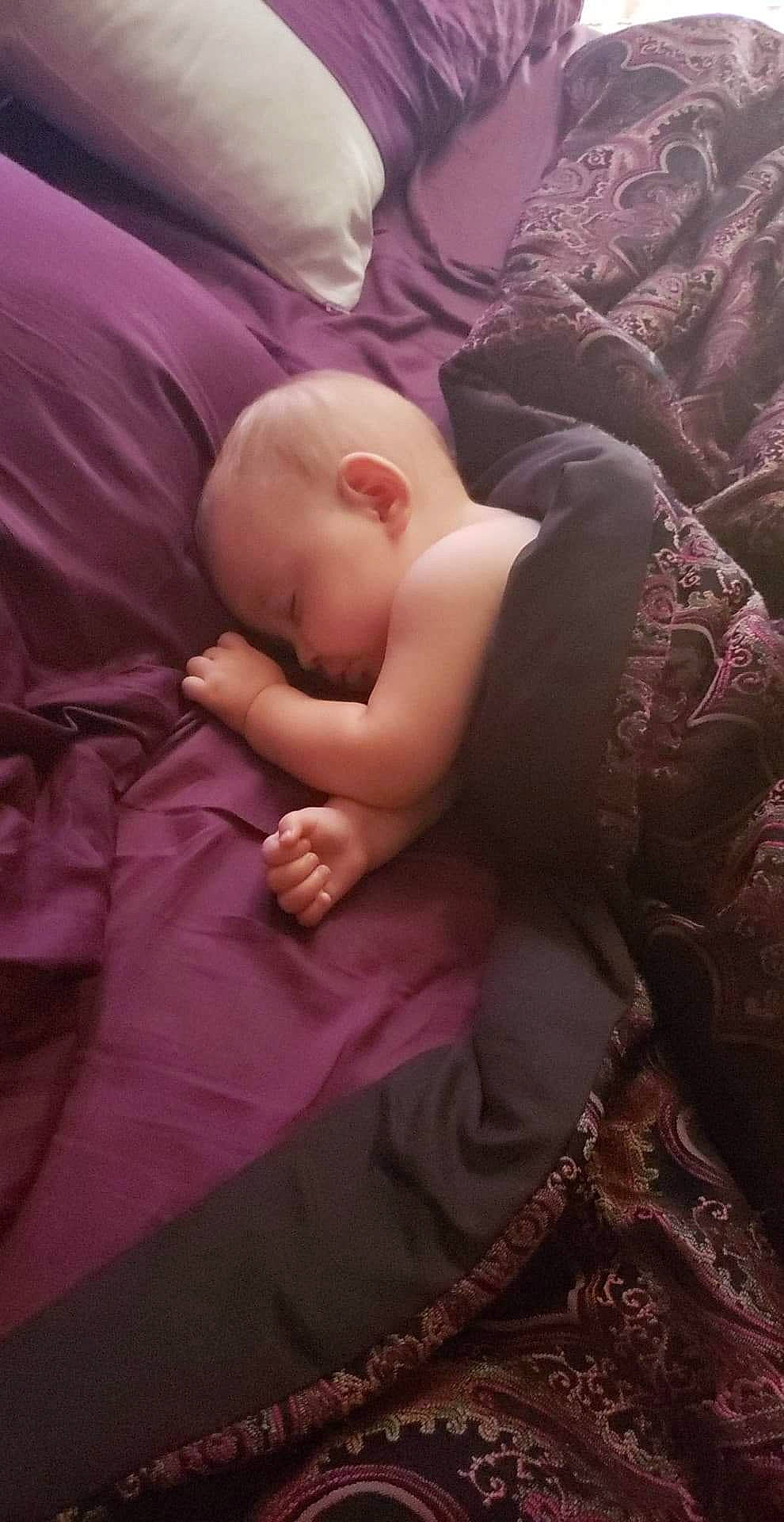 Aylin is registered to the contest to win money with this photo: arm, baby, bedtime, cheek, child, hand, mouth, muscle, nap, person, purple, sleep, toddler