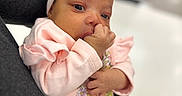 Elaysha is registered to the contest to win money with this photo: adorable, baby, baby_girl, child, closeup, clothing, cute, flower, hand, headband, holding, indoor, infant, person, pink_clothing, portrait, sleeves, soft_focus, thumb_sucking, young_child