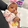 adorable, baby, baby_girl, child, closeup, clothing, cute, flower, hand, headband, holding, indoor, infant, person, pink_clothing, portrait, sleeves, soft_focus, thumb_sucking, young_child
