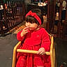 Aylin participe au concours pour gagner de l'argent avec cette photo : toddler, child, red_dress, headband, high_chair, restaurant, indoor, wooden_furniture, nibbling, curious, warm_lighting, carpet, white_shoes, baby, small_child, seated, person, cute, cozy, dim_light