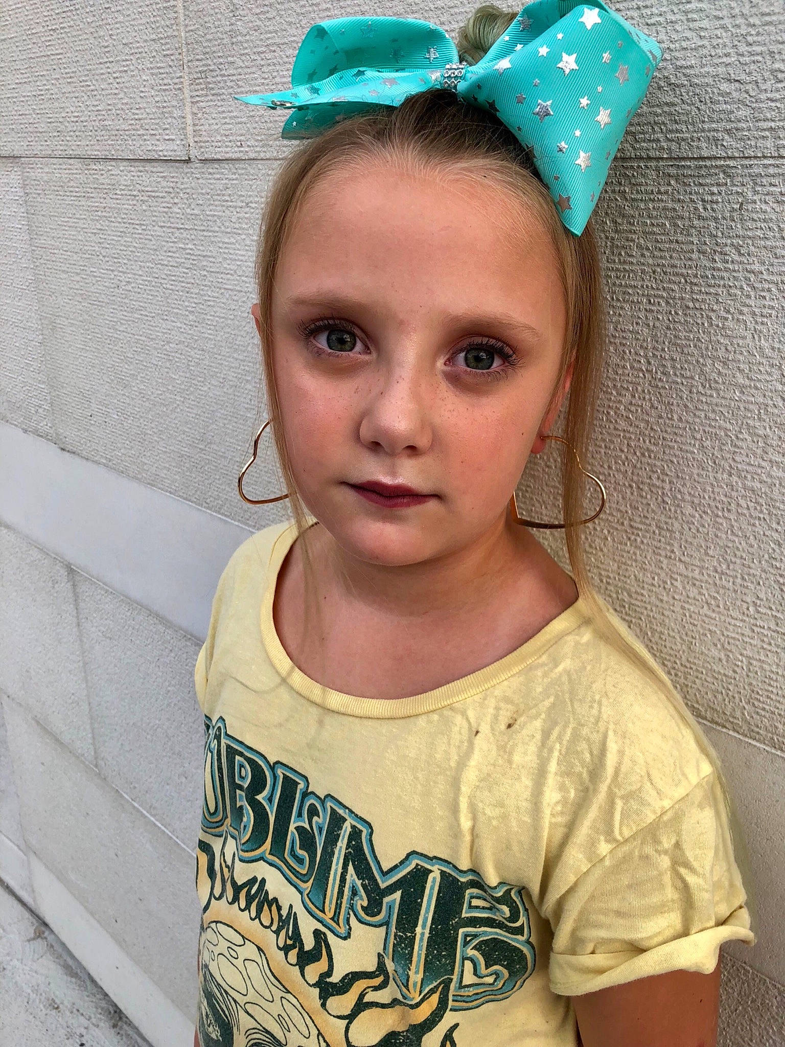 Bradleigh is registered to the contest to win money with this photo: child, clothing, costume_accessory, costume_hat, ear, fashion_accessory, forehead, hair, hair_accessory, head, headband, headgear, headpiece, person, smile, t_shirt, toddler, turquoise