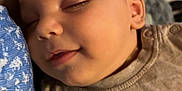 Soren participe au concours pour gagner de l'argent avec cette photo : baby, sleeping, face, child, skin, closeup, peaceful, smile, rest, comfort, human, infant, head, apparel, fabric, pattern, arm, portrait, indoors, relaxation